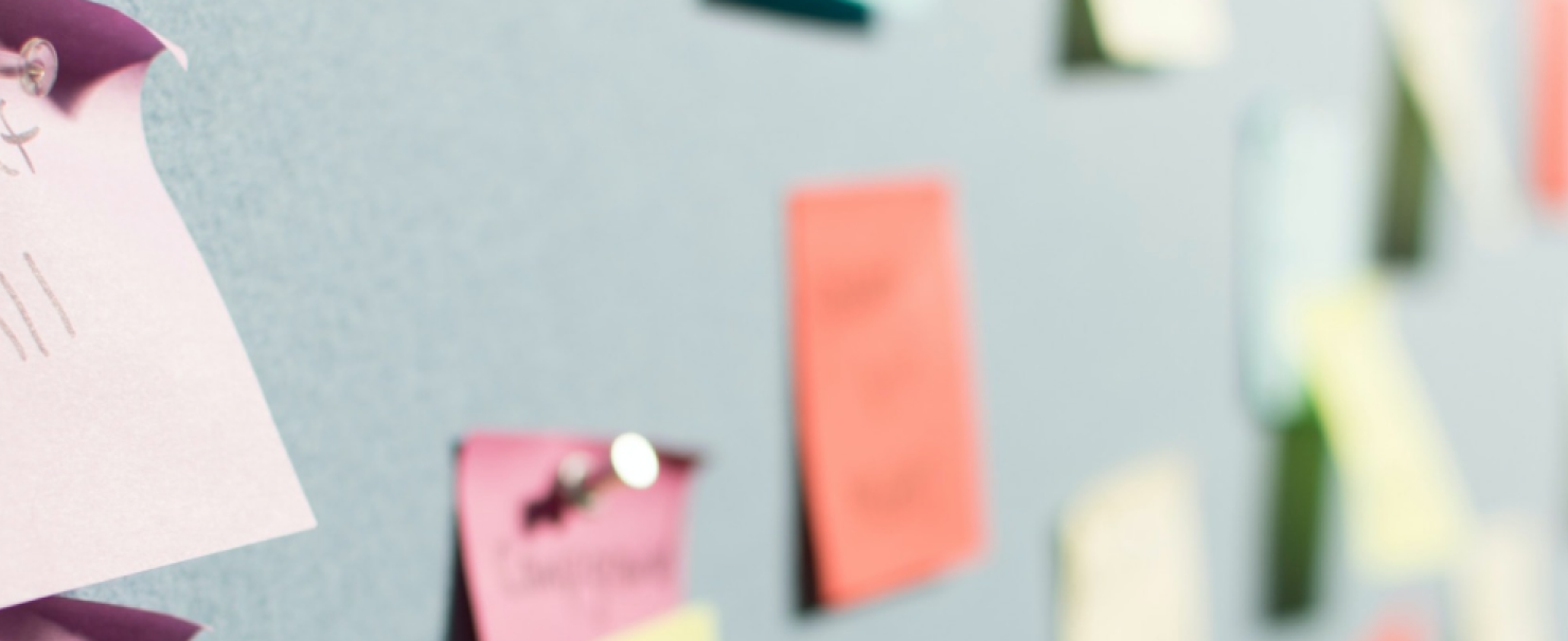 Image of blue wall with colorful post-its and a shallow depth of field.