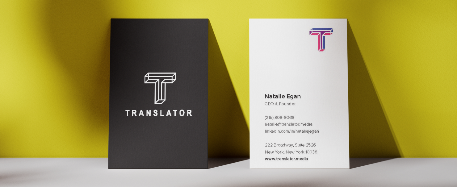 Two business cards on a yellow surface