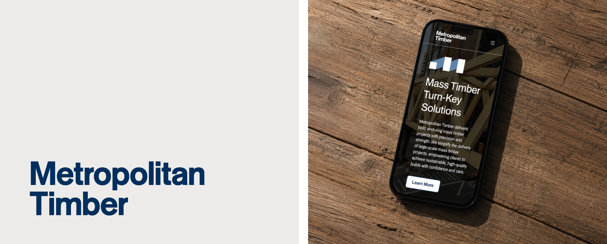 Metropolitan Timber wordmark and mobile website mockup on wood surface